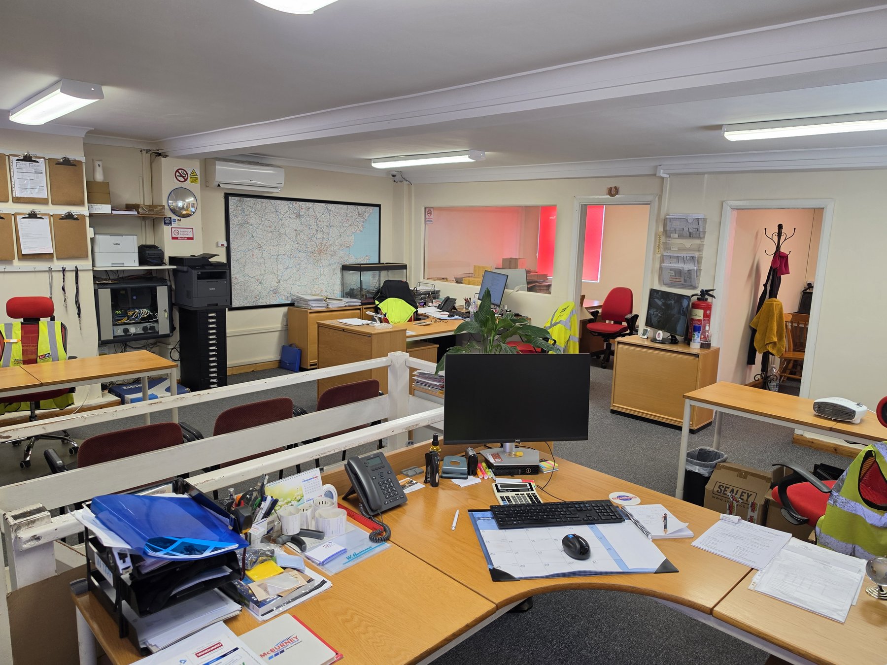 Excess Luggage Co. operations team at Heathrow area office — coordinating global luggage and freight shipments