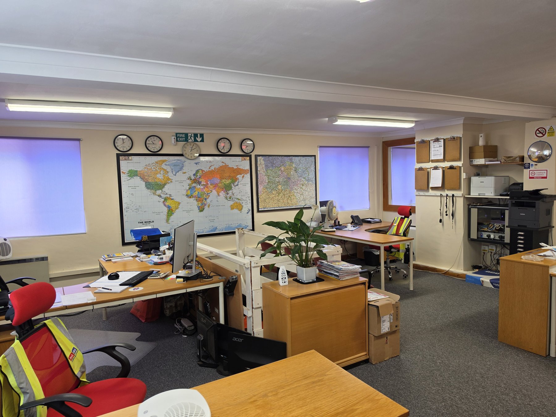 Excess Luggage Co. operations office, Hounslow — world map, timezone clocks, active team handling international shipments