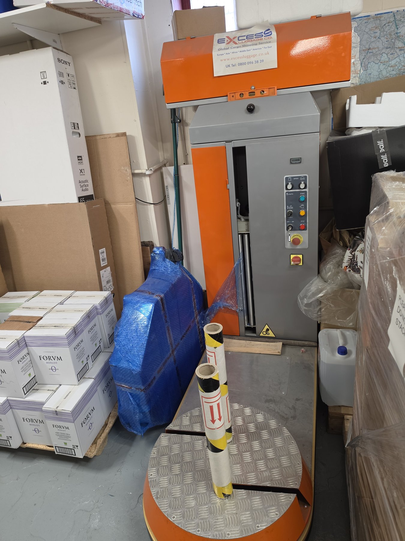 Excess Luggage Co. luggage wrap machine at Hounslow warehouse — Global Cargo Shipping Service, Heathrow