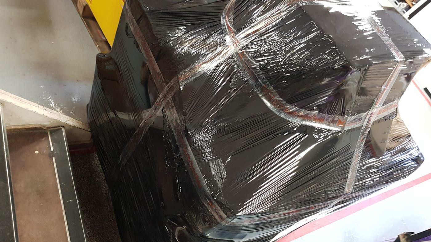 A pallet of personal effects shrink-wrapped for export