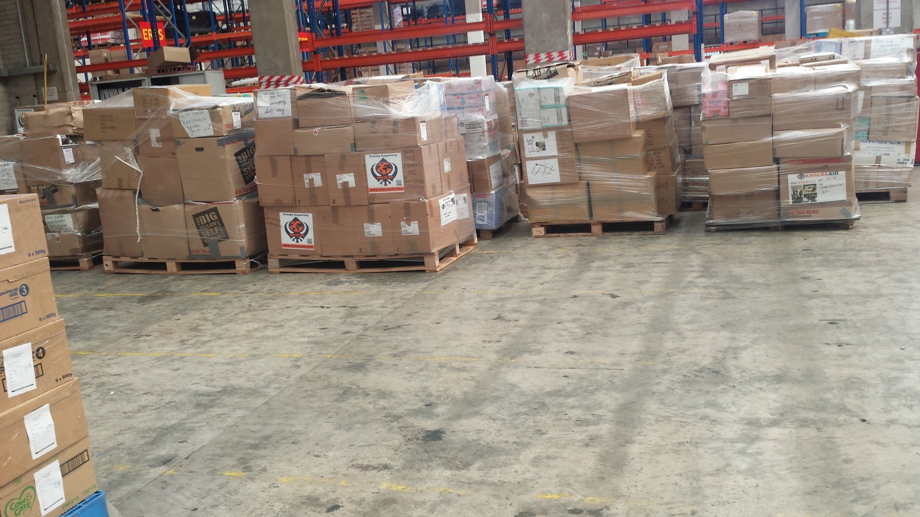Khalsa Aid Nepal earthquake relief cargo palletised at Excess Luggage Co. warehouse — Hounslow, near Heathrow